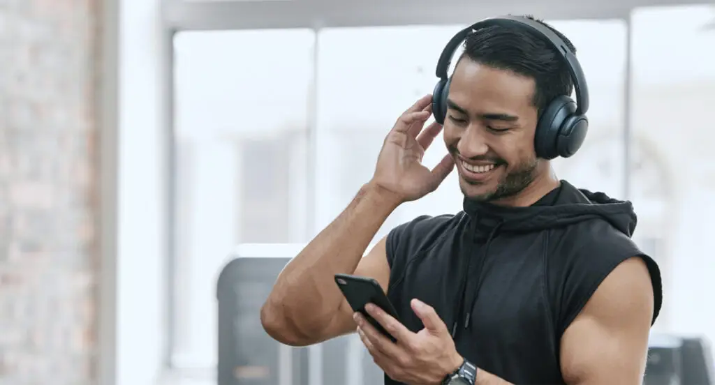 Man using cell phone at fitness center