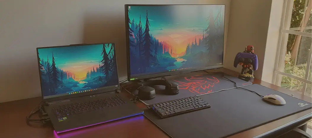 Modern laptop computer neon light room setup