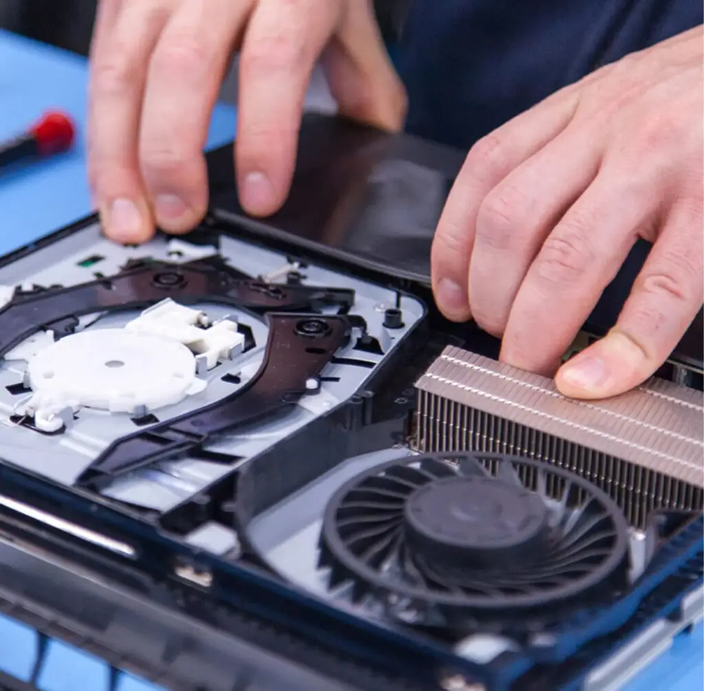 Technician fixing video game console fan